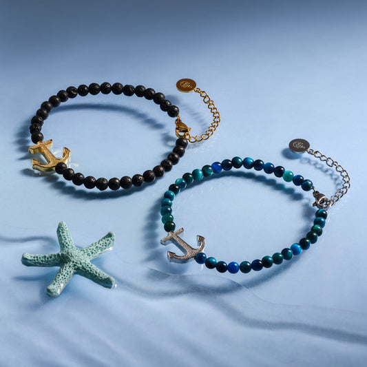 Two Alison Mariot anchor bracelets in natural volcanic stone and blue tiger eye with 18K gold PVD