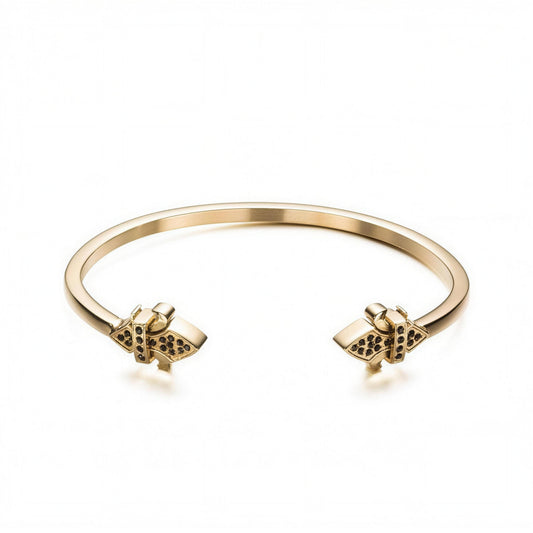 Alison Mariot fleur-de-lis bangle in 316L steel with 18K gold PVD emblem