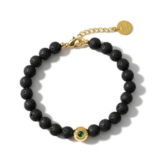 Alison Mariot Black Evil Eye bracelet with natural volcanic lava stones, 18K gold PVD evil eye and green Swarovski crystal