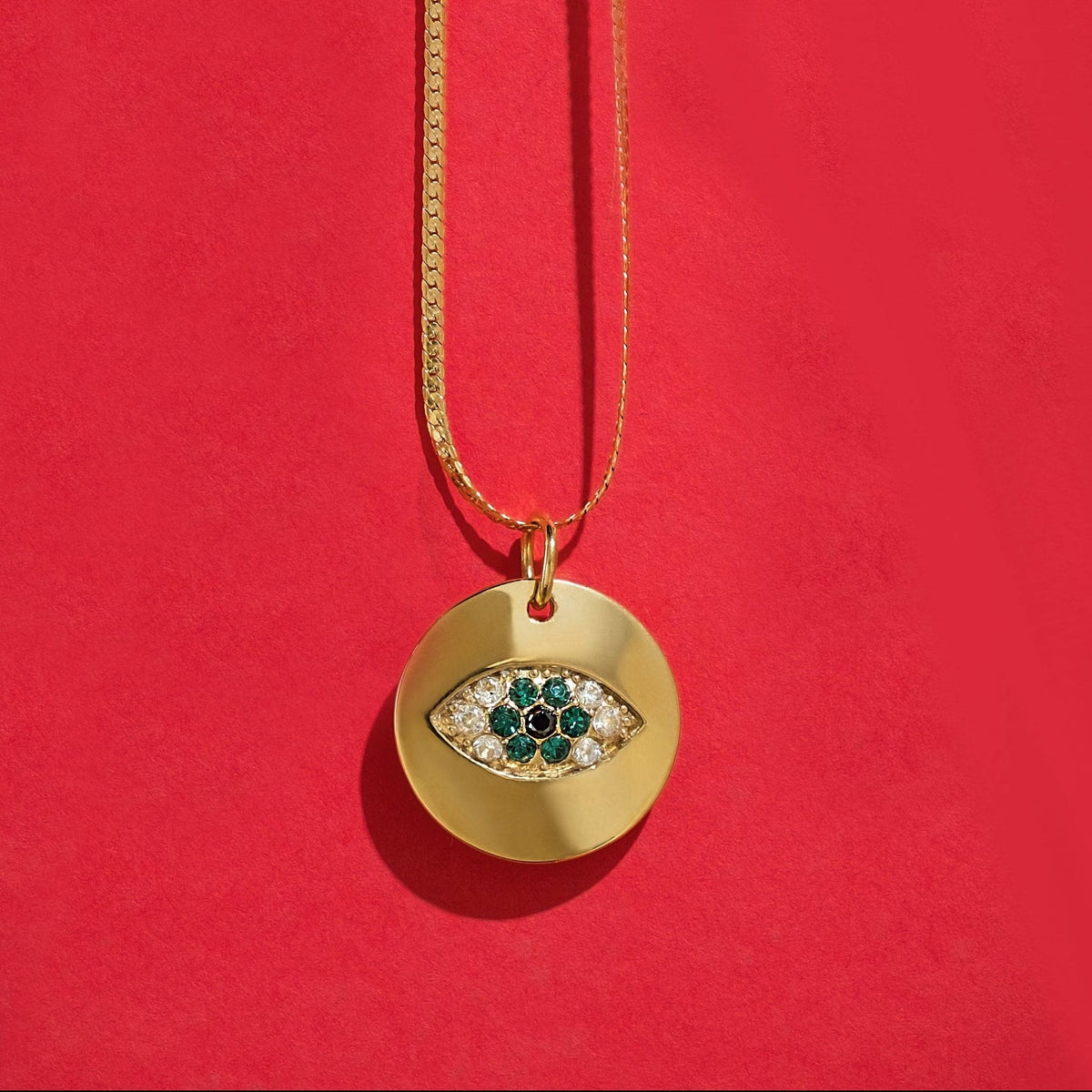 Alison Mariot evil eye necklace in 18K gold vermeil with green Swarovski crystals