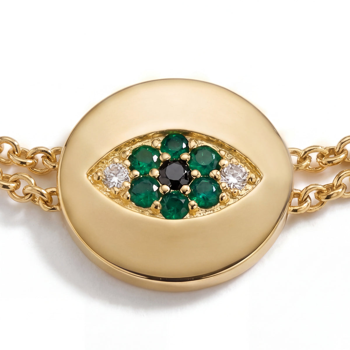 Alison Mariot Emerald evil eye bracelet — close-up of the crystal eye medallion