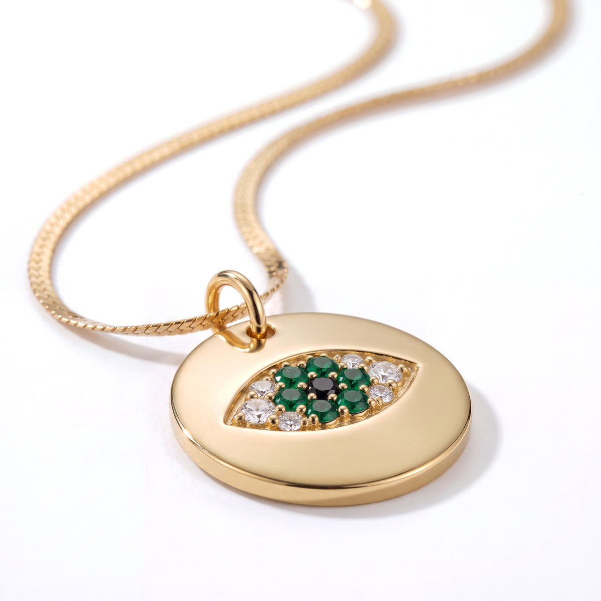 Alison Mariot Emerald evil eye necklace with green crystals — angled view
