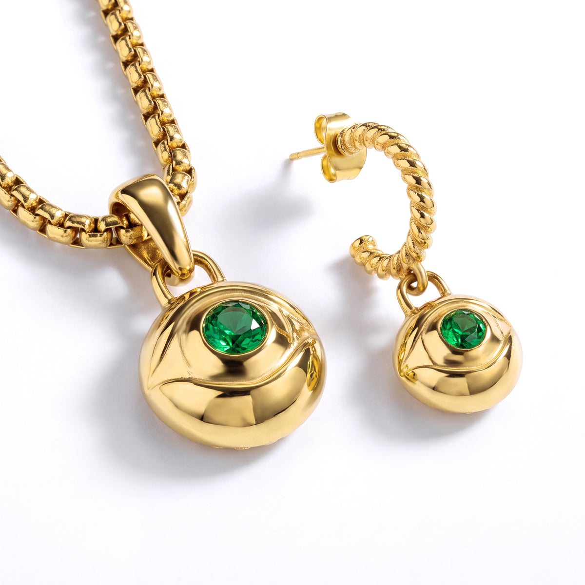 Alison Mariot evil eye pendant and earring — close-up of the green crystal eye