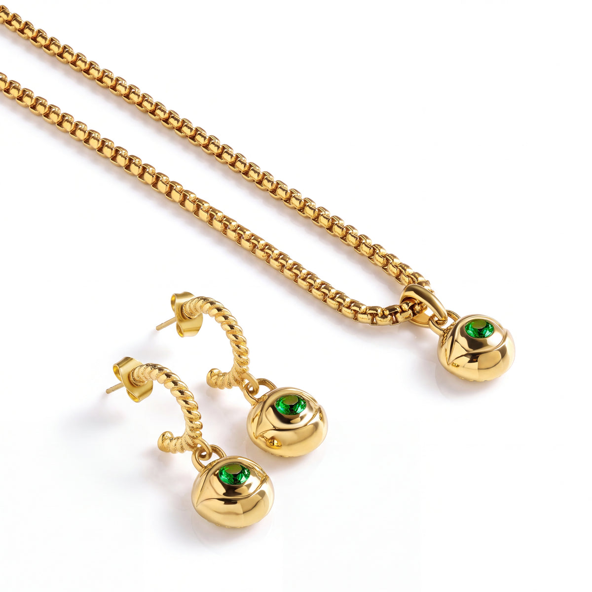 Alison Mariot evil eye necklace and earrings with green crystals — angled view