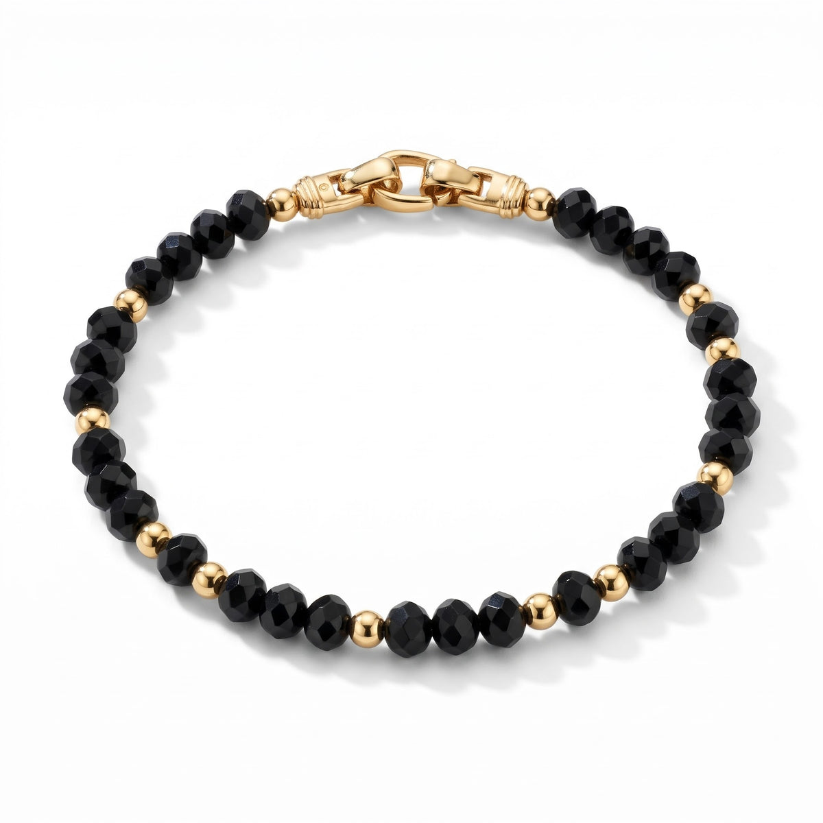 Alison Mariot AVÉRON bracelet in natural faceted black onyx with titanium and 18K gold PVD — angled view
