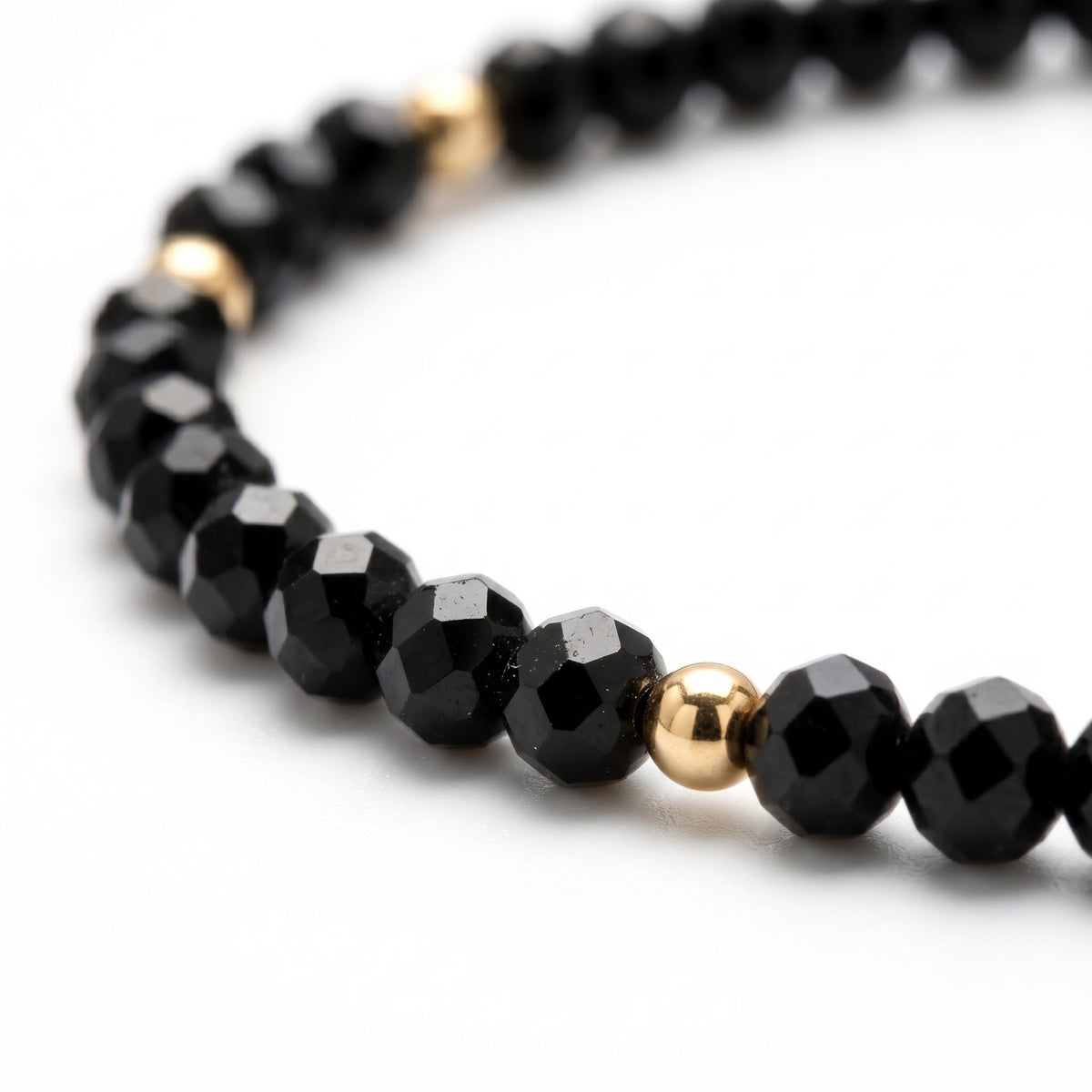 Alison Mariot AVÉRON necklace — close-up of the faceted black onyx and 18K gold PVD beads